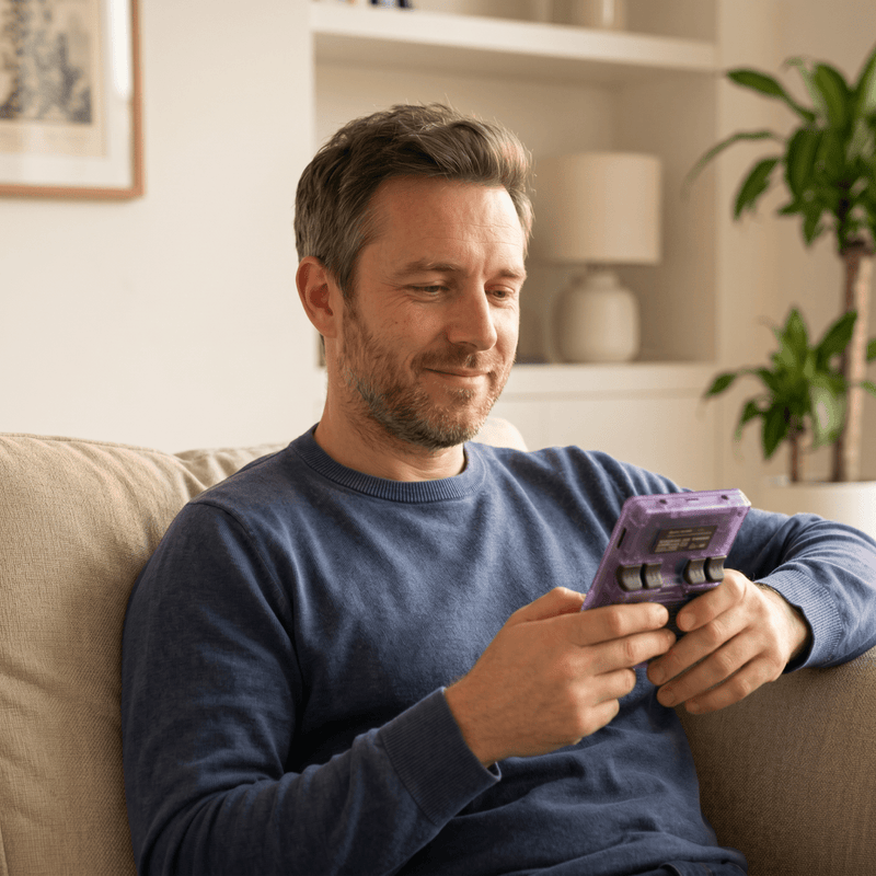 Person playing the Trysoviren Pro 2.0 R36S retro gaming console at home