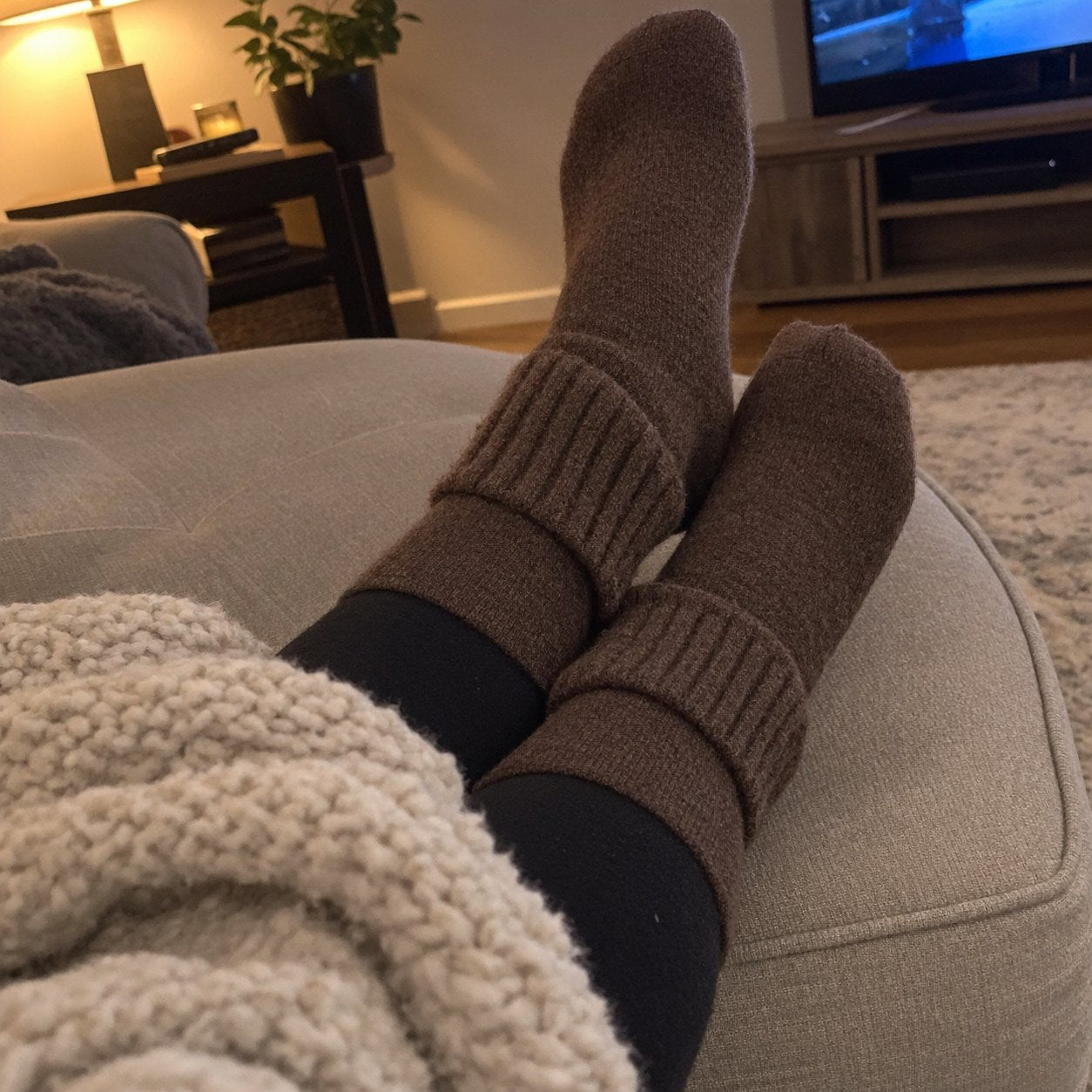 Brown socks worn on a couch